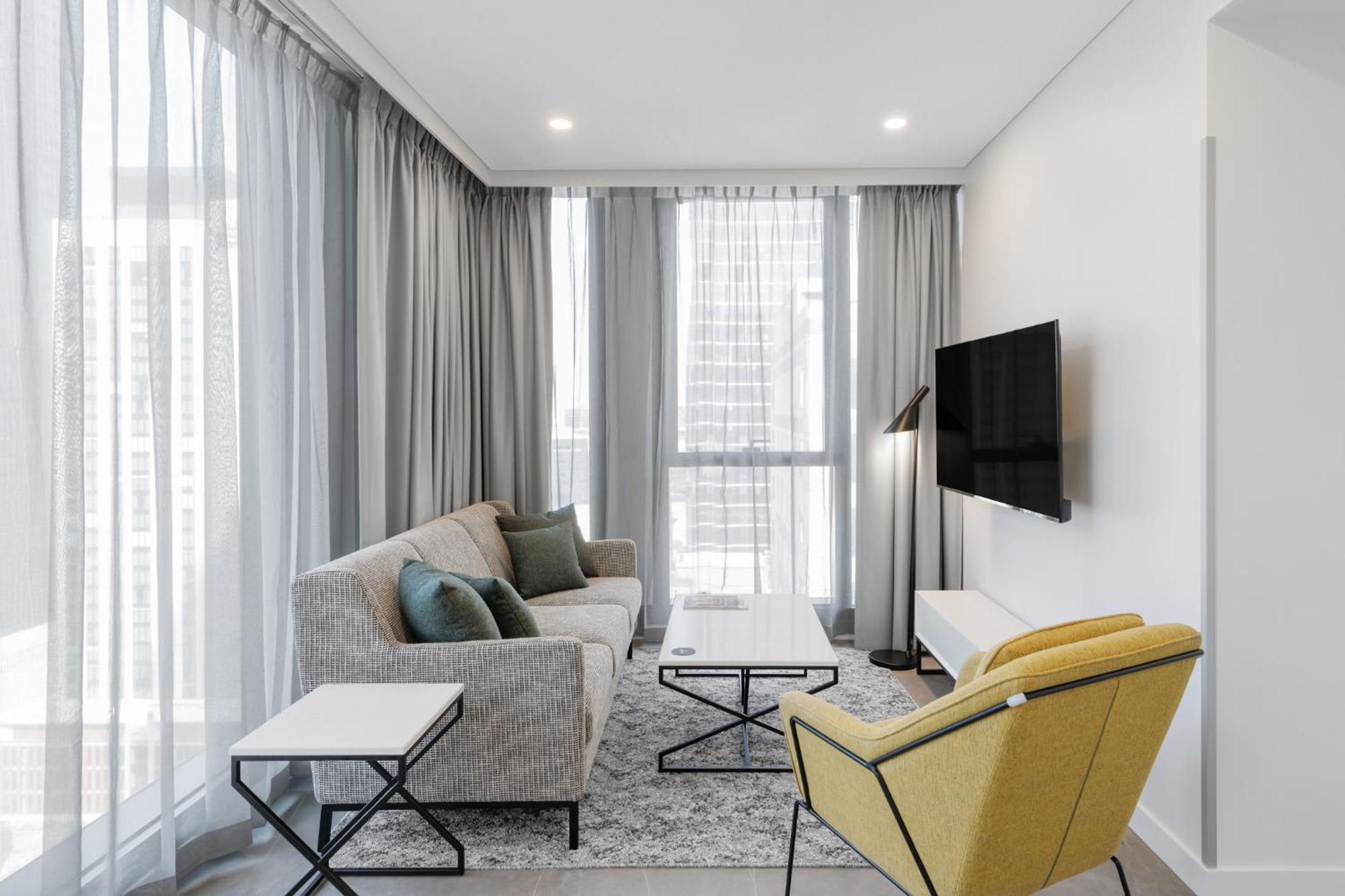 Meriton Suites Melbourne Exterior foto A living room in a typical apartment
